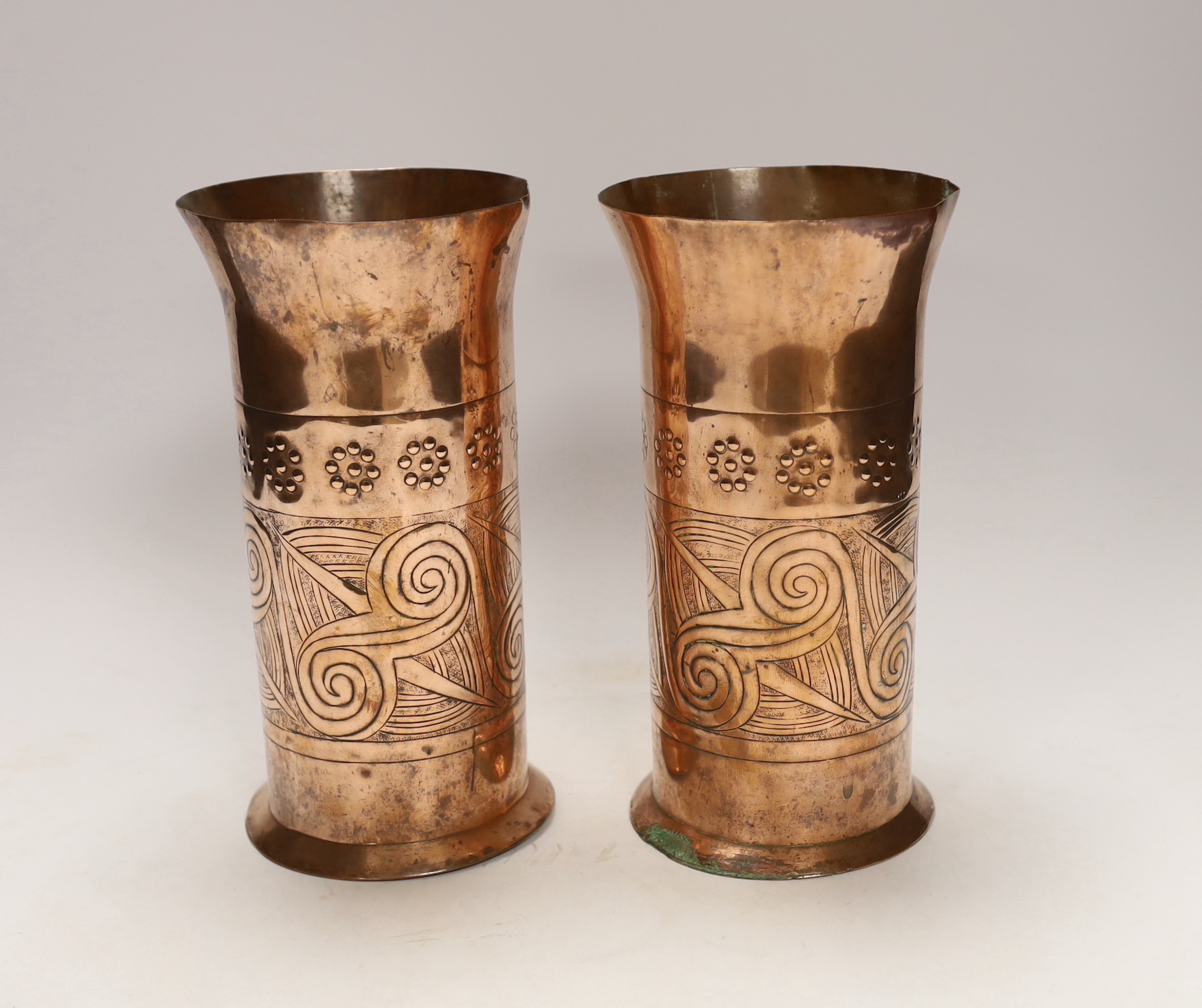 A pair of Keswick School of industrial art embossed copper cylinder vases, stamped KSIA to the bases, 20cm high